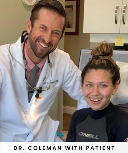 member of dental staff smiling with patient